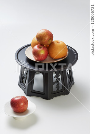 Plenty of fruit placed on plates above and below the refreshment table 120006721