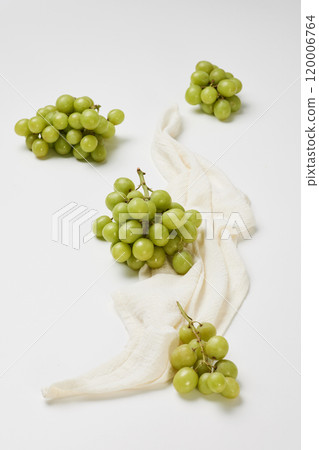 Several bunches of grapes placed with a cloth on a white background Several bunches of grapes placed with a cloth on a white background 120006764
