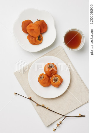 Luxurious plating of dried persimmons, a traditional Korean dessert Luxurious plating of dried persimmons, a traditional Korean dessert 120006806