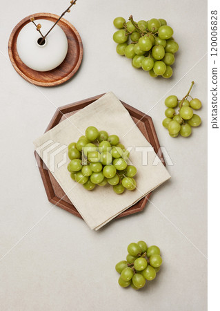Fresh green grapes placed inside a wooden tray Fresh green grapes placed inside a wooden tray 120006828
