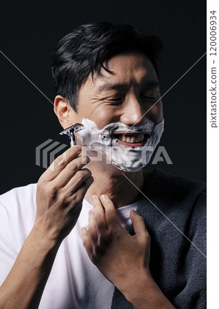 A middleaged man about to start shaving 120006934