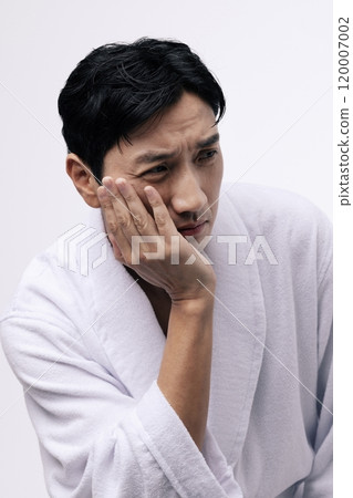 A middleaged man with his chin resting A middleaged man with his chin resting 120007002