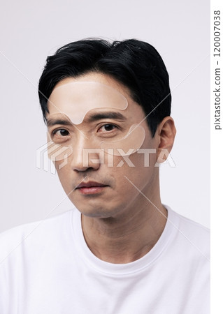 Middleaged man with cosmetic patches on his face 120007038