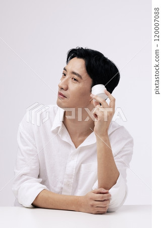 A middleaged man holding a can of cream A middleaged man holding a can of cream 120007088