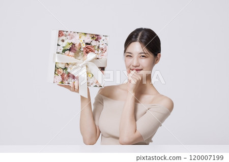 Gift box full of flowers tied with white ribbon 120007199