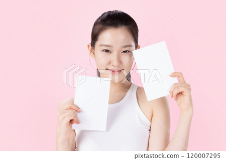 Teenage woman posing with a card 120007295
