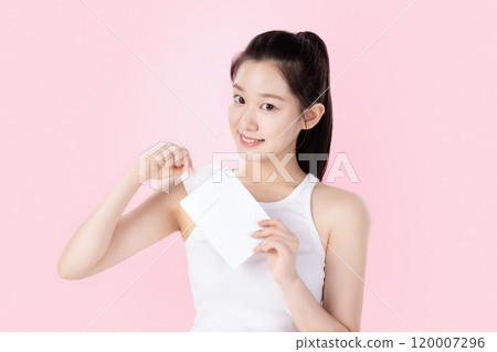 Teenage woman posing with a card 120007296