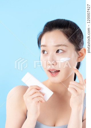 A teenage woman posing with cosmetics A teenage woman posing with cosmetics 120007427