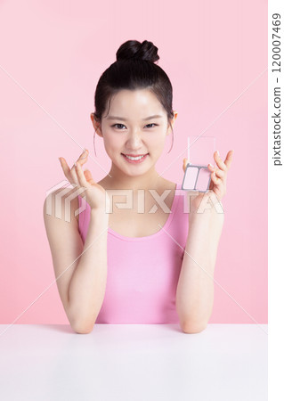 A teenage woman posing with blusher 120007469
