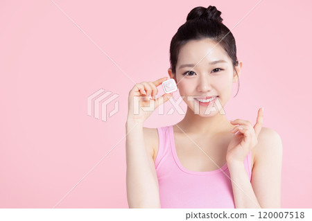 A teenage woman posing with cosmetics A teenage woman posing with cosmetics 120007518