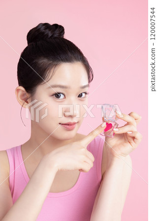 A teenage woman posing with cosmetics A teenage woman posing with cosmetics 120007544