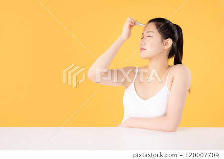 Teenage woman using ointment to remove skin problems on her face 120007709