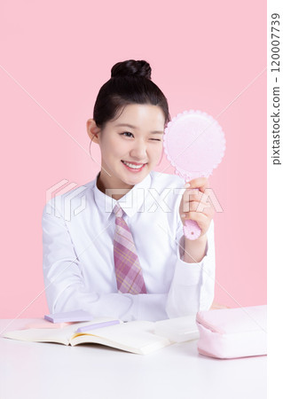 A teenage woman wearing a school uniform and holding cosmetics in a cute pose 120007739