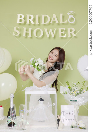 A woman in her 20s enjoying a bridal shower ahead of her wedding A woman in her 20s enjoying a bridal shower ahead of her wedding 120007765