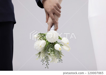 Newlyweds' hands holding a bouquet Newlyweds' hands holding a bouquet 120007865