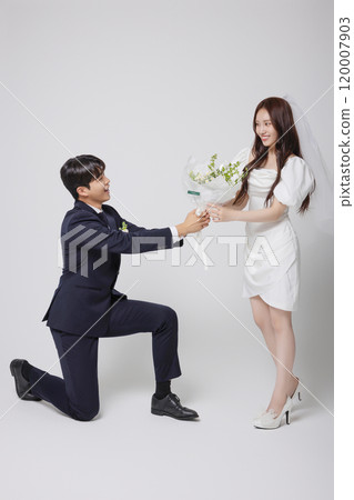 Newlyweds taking a wedding photo shoot 120007903
