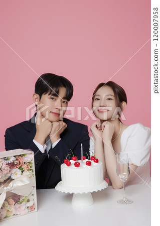 Newlywed couple smiling happily holding wedding cake Newlywed couple smiling happily holding wedding cake 120007958