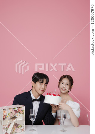 Newlywed couple smiling happily holding wedding cake 120007976