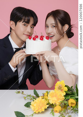 Newlywed couple smiling happily holding wedding cake 120007986
