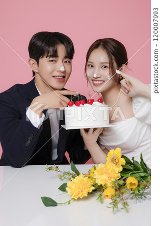Newlywed couple smiling happily holding wedding cake 120007993