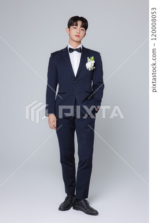 A man in his 20s wearing a suit and taking a wedding photo shoot A man in his 20s wearing a suit and taking a wedding photo shoot 120008053