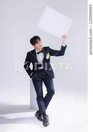 A man in his 20s wearing a suit and taking a wedding photo shoot A man in his 20s wearing a suit and taking a wedding photo shoot 120008065