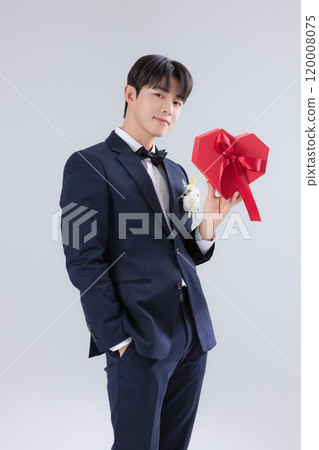 A man in his 20s wearing a suit and taking a wedding photo shoot A man in his 20s wearing a suit and taking a wedding photo shoot 120008075