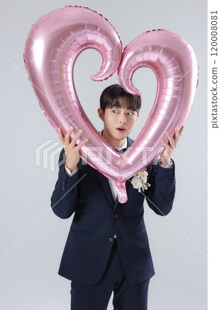 A man in his 20s wearing a suit and taking a wedding photo shoot A man in his 20s wearing a suit and taking a wedding photo shoot 120008081