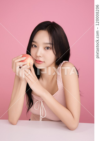 A woman in her 20s holding a peach and holding various poses A woman in her 20s holding a peach and holding various poses 120008206