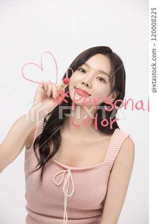 A woman in her 20s writing on a transparent wall with lipstick 120008225