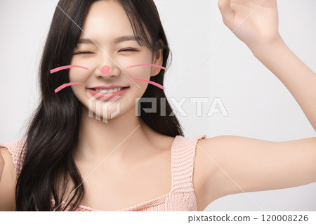 Woman in her 20s drawing cat whiskers and striking a cute pose 120008226