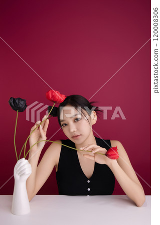 A woman in her 20s showing an elegant pose using poppy flowers 120008306