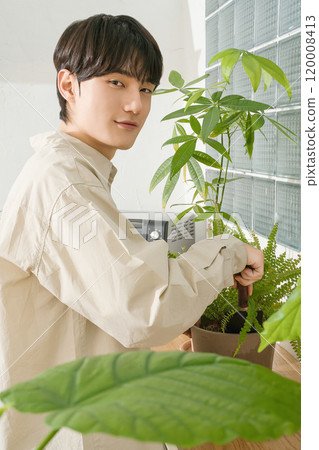 A man in his 20s with a hobby of growing plants A man in his 20s with a hobby of growing plants 120008413