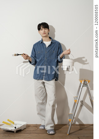 A man in his 20s painting a wall A man in his 20s painting a wall 120008505