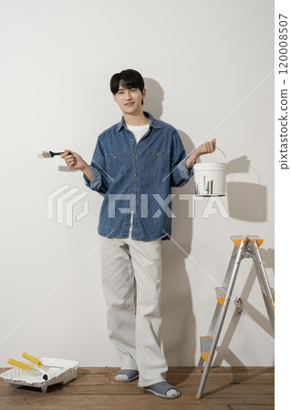 A man in his 20s painting a wall A man in his 20s painting a wall 120008507