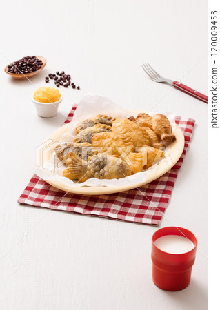 Red bean bungeoppang puff pastry and cream bungeoppang beautifully plated on a red checkered tablecloth 120009453