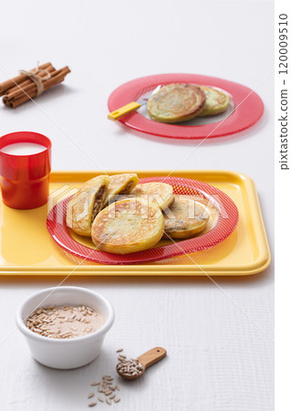 Cutely plated hotteok with milk on a yellow tray 120009510