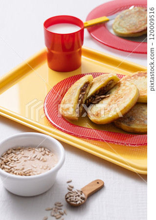 Cutely plated hotteok with milk on a yellow tray 120009516