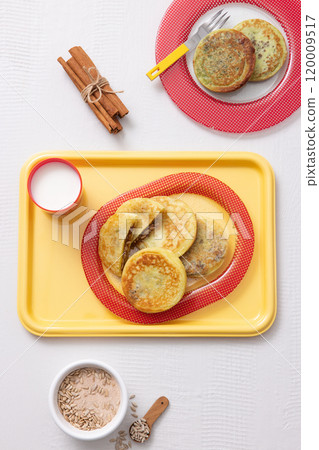 Cutely plated hotteok with milk on a yellow tray 120009517