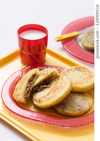 Cutely plated hotteok with milk on a yellow tray Cutely plated hotteok with milk on a yellow tray 120009518