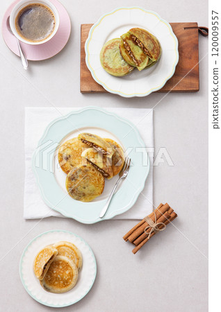 A combination of warm coffee and delicious hotteok A combination of warm coffee and delicious hotteok 120009557