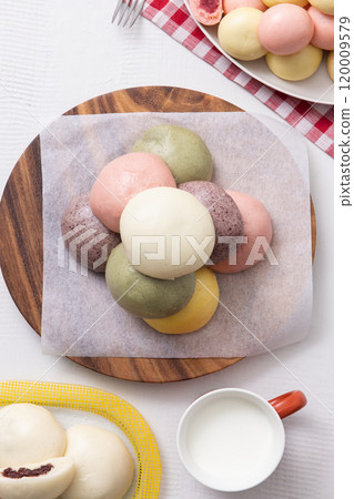 Cutely plated colorful and warm buns and milk 120009579