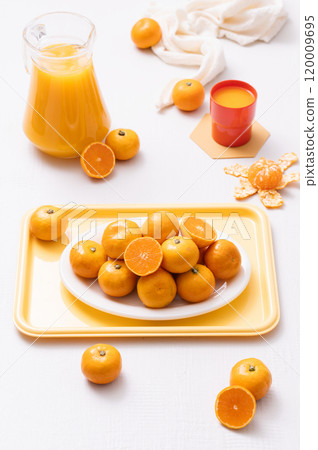 Delicious tangerines plated on a tray and a drink made from tangerines Delicious tangerines plated on a tray and a drink made from tangerines 120009695