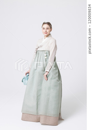 Western woman wearing Hanbok and holding a gift wrapped in Korean style Western woman wearing Hanbok and holding a gift wrapped in Korean style 120009834