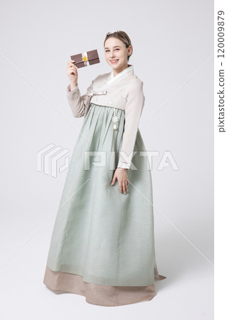 A foreign woman wearing traditional Korean hanbok holding a holiday gift 120009879