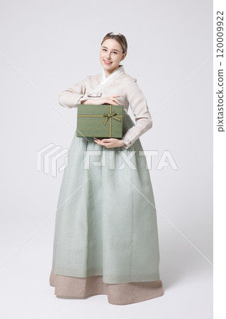 A foreign woman wearing traditional Korean hanbok holding a holiday gift A foreign woman wearing traditional Korean hanbok holding a holiday gift 120009922