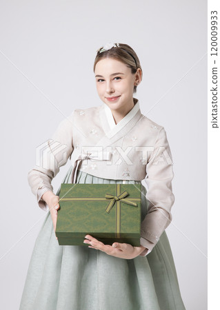 A foreign woman wearing traditional Korean hanbok holding a holiday gift A foreign woman wearing traditional Korean hanbok holding a holiday gift 120009933