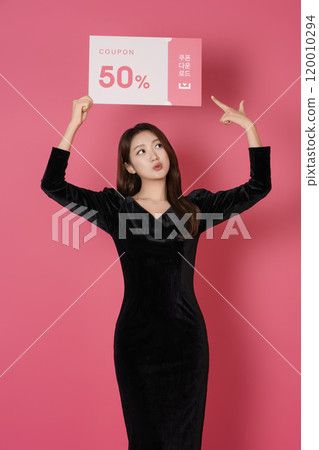 A woman in her 20s posing with a 50 percent discount coupon 120010294
