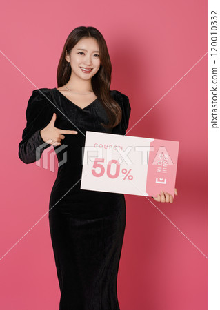 A woman in her 20s posing with a 50 percent discount coupon 120010332