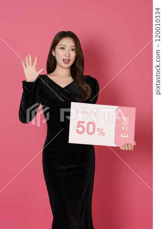 A woman in her 20s posing with a 50 percent discount coupon 120010334